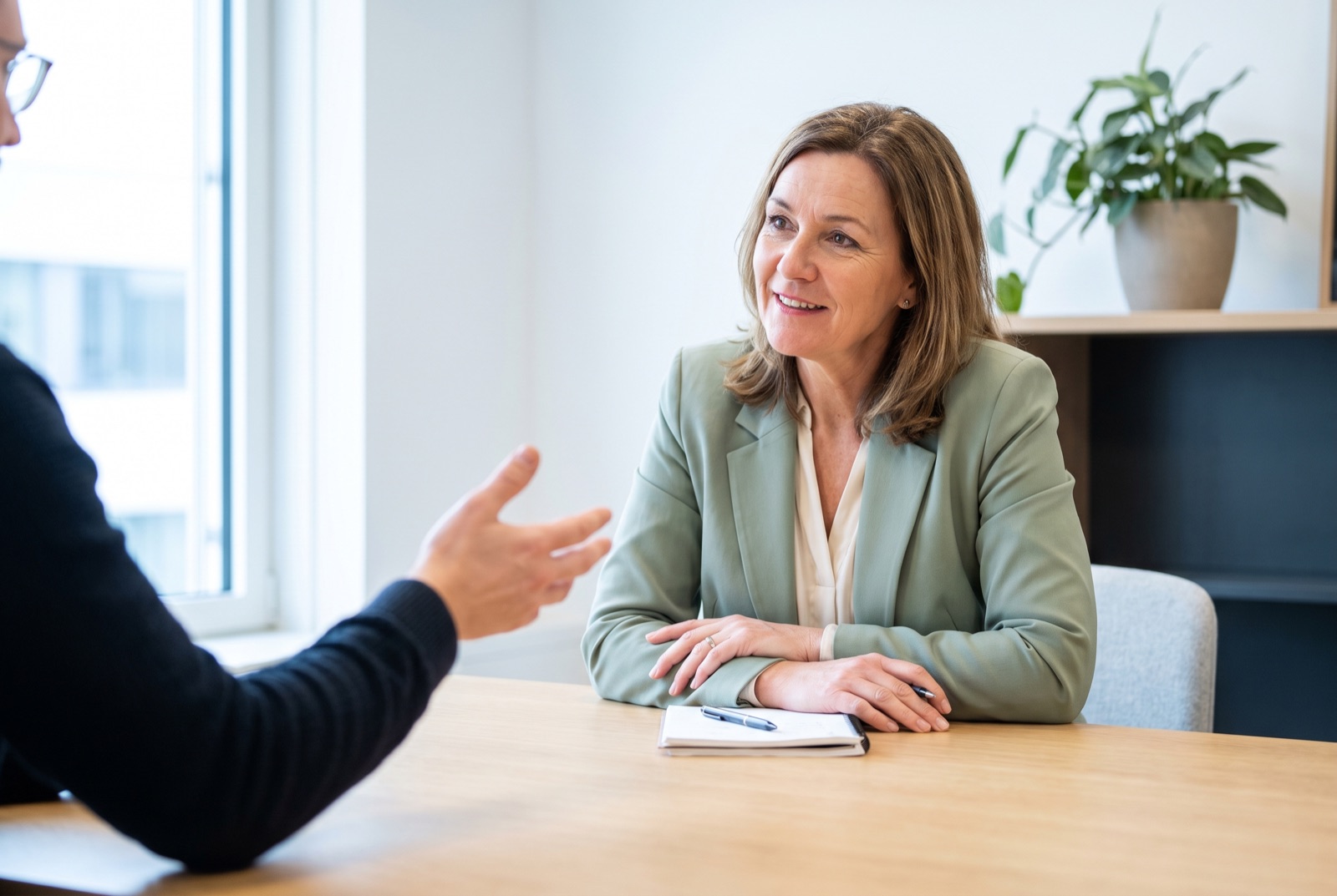 An advisor listening attentively while a client explains their situation across the table