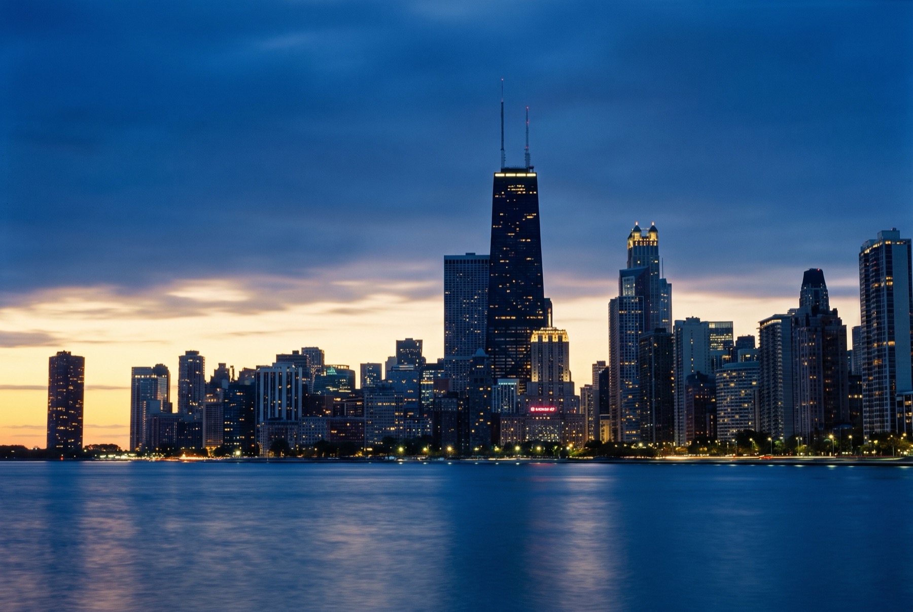 Chicago skyline at dusk across Lake Michigan